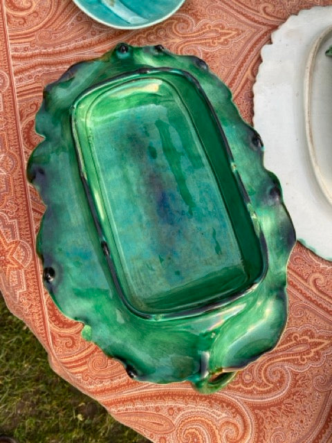 Plat à asperges ancien en barbotine sur sa feuille de chou